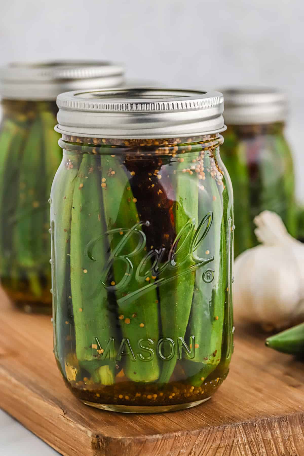 a close up of a jar of quick pickled okra