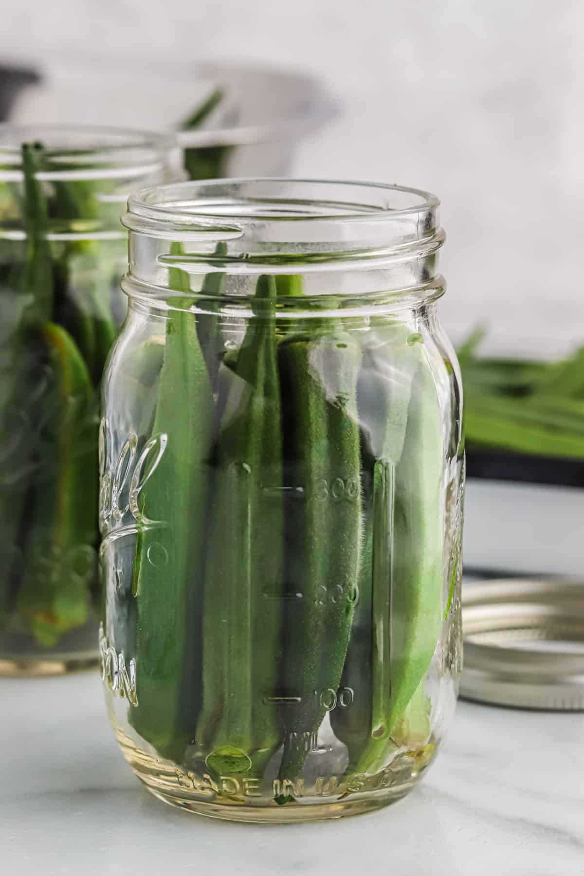 Okra packed into a jar without the spices.
