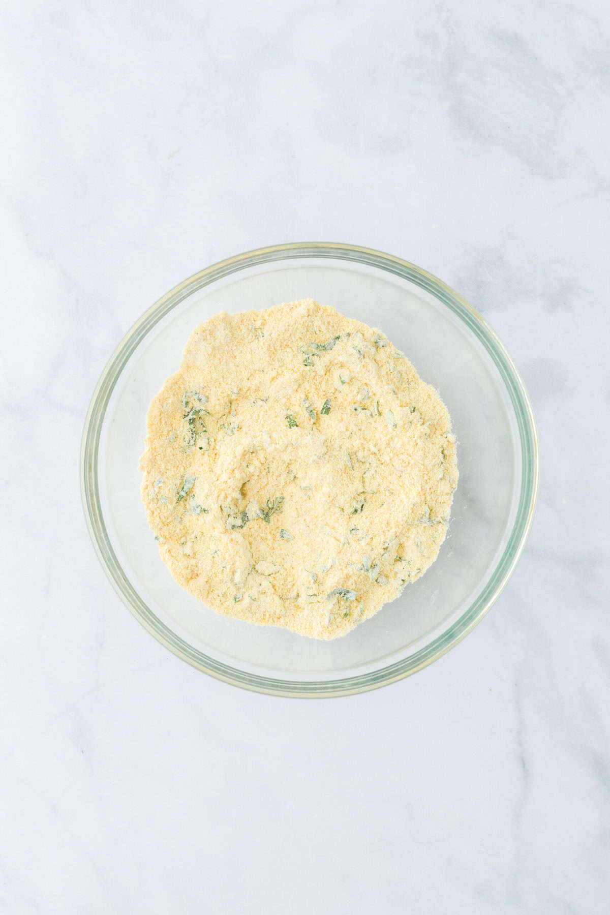 Dry ingredients to make hushpuppy recipe mixed together in a clear mixing bowl