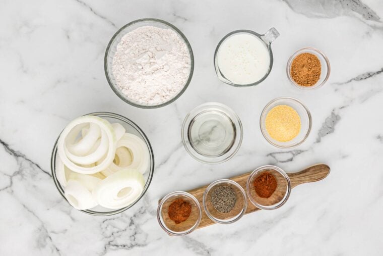 Ingredients to make crispy onion rings recipe on the table ready to cook.