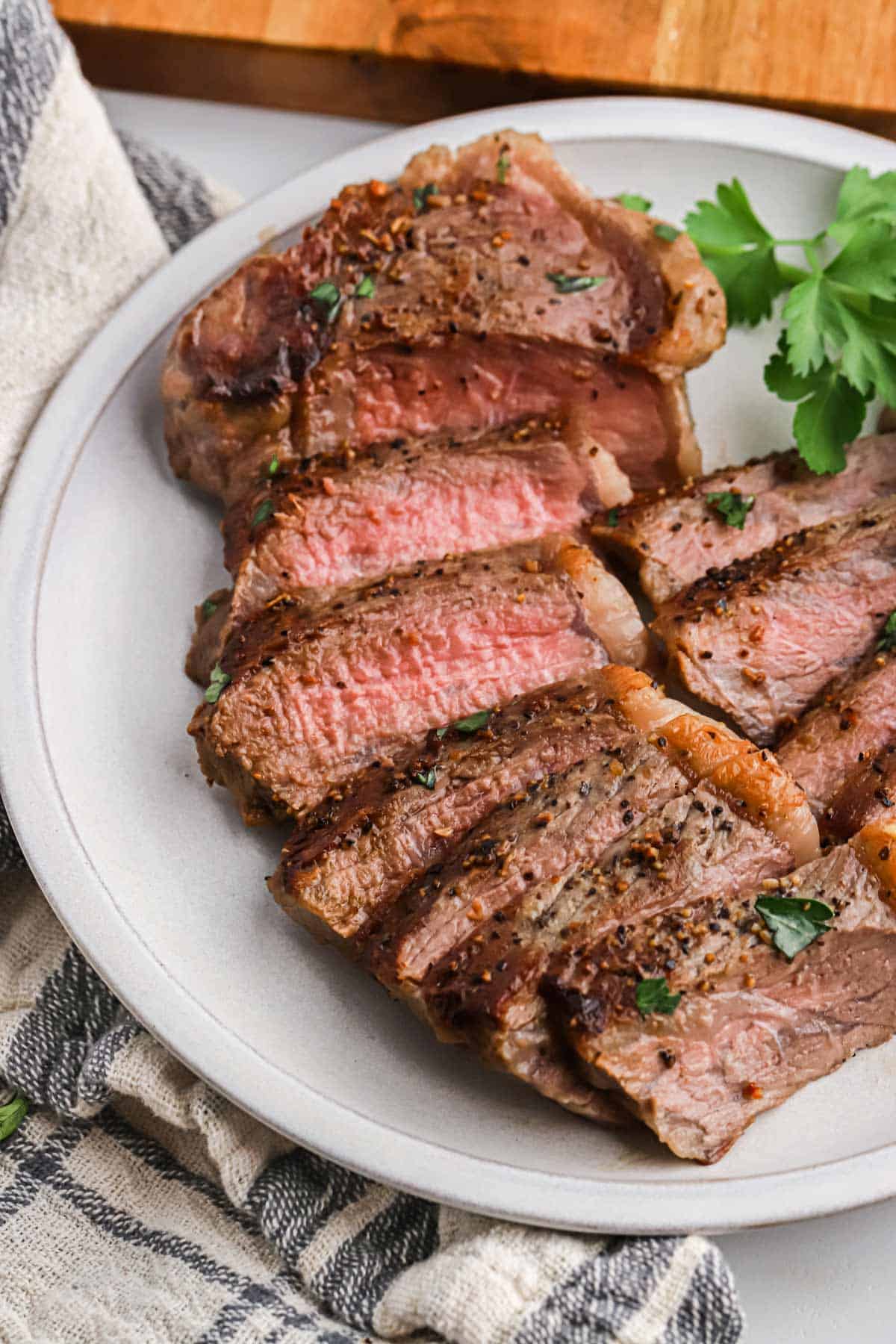 Sliced seared steak on a plate.