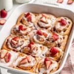 Strawberry shortcake cinnamon rolls ready to serve in baking dish