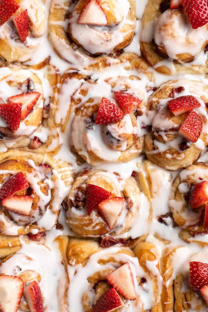 An overhead of strawberry shortcake cinnamon rolls ready to enjoy