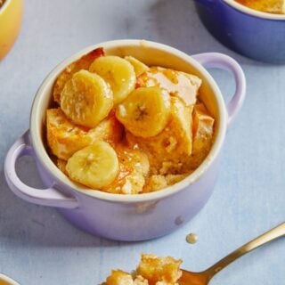 Bananas Foster Bread Pudding in small ramekins on a gray background