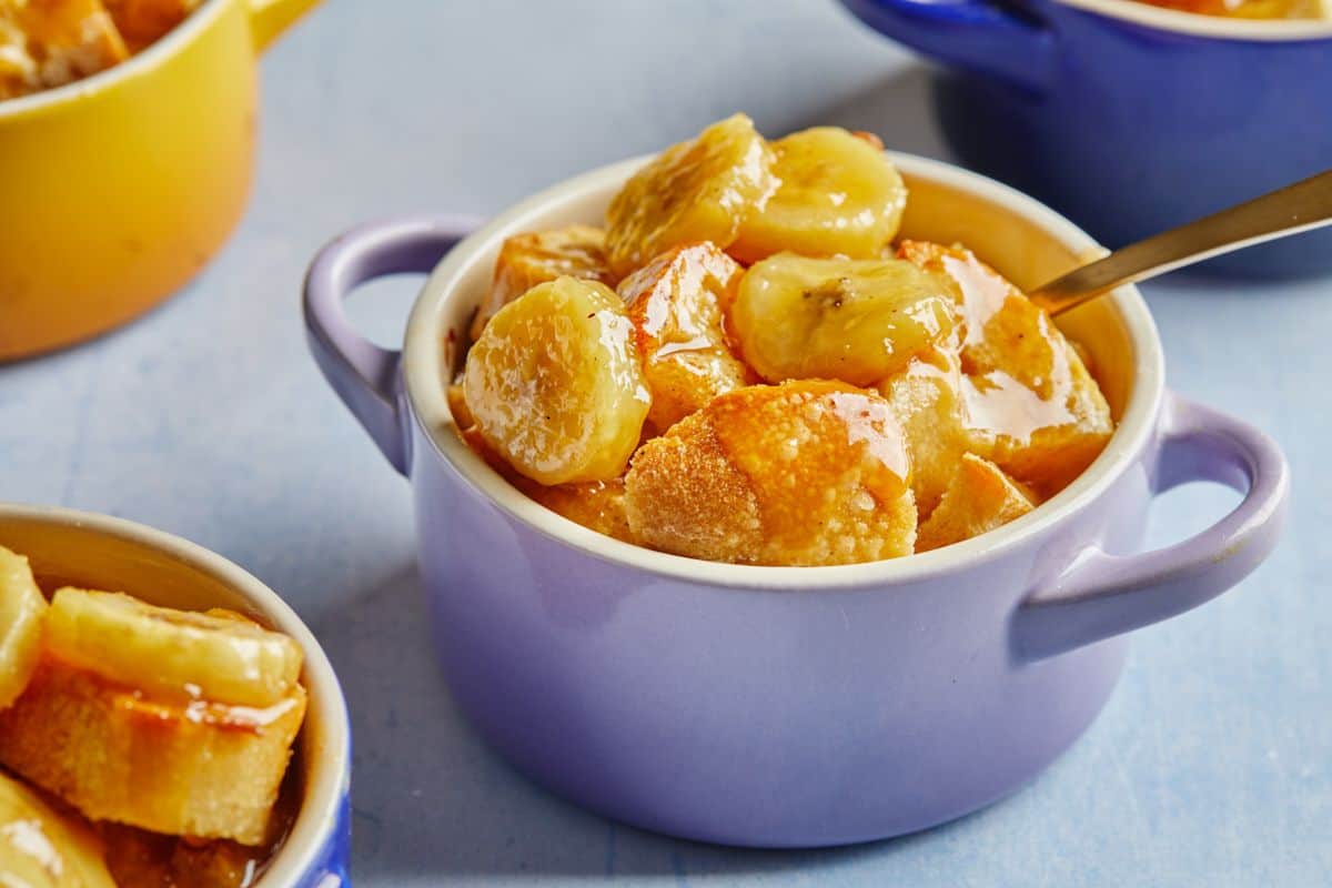 A delicious bananas foster bread pudding with a rum sauce ready to serve in blue ramekins