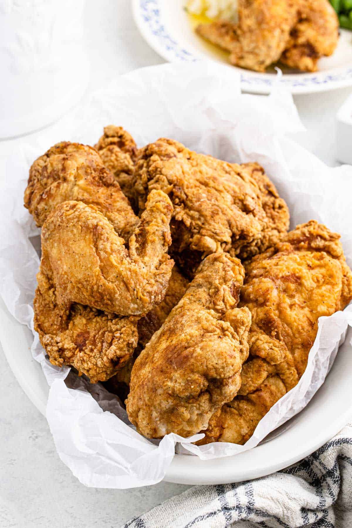 Fried chicken recipe served up in a basket with a piece of paper underneath.