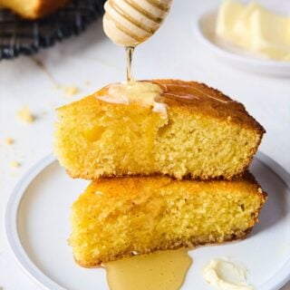Slices of cornbread with honey and butter on top