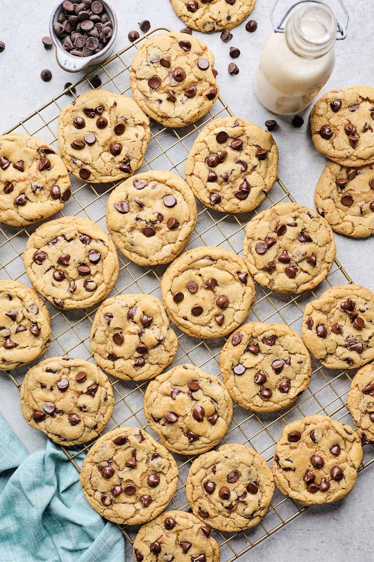 Overhead of several best chewy chocolate chip cookies against wire rack and white background