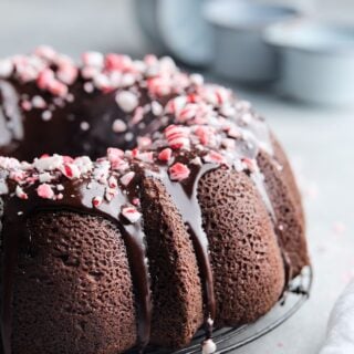 Ultimate Chocolate Pound Cake with Peppermint Ganache Glaze on a gray background