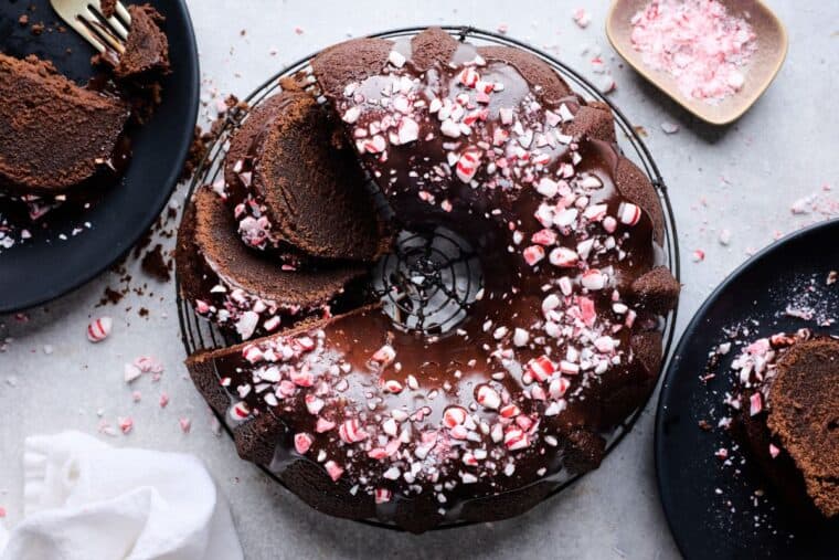 An overhead of chocolate pound cake with rich ganache glaze and peppermint crushed on top ready to serve