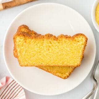 Two slices of cornmeal cake stacked on a plate at slightly different angles.