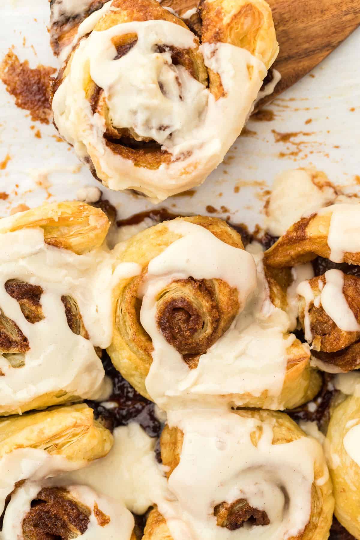 Easy cinnamon rolls after being baked and covered in glaze ready to serve in the baking pan.