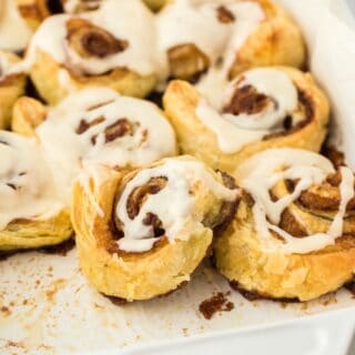 Baked easy cinnamon rolls in a pan with a few missing.