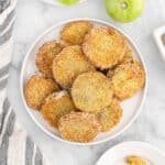 fried green tomatoes on a white background on a white plate with striped napkin