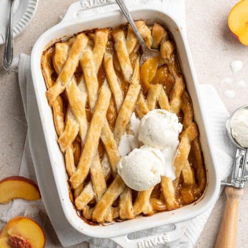 Southern Peach Cobbler Recipe on a beige background with ice cream on top with peaches around