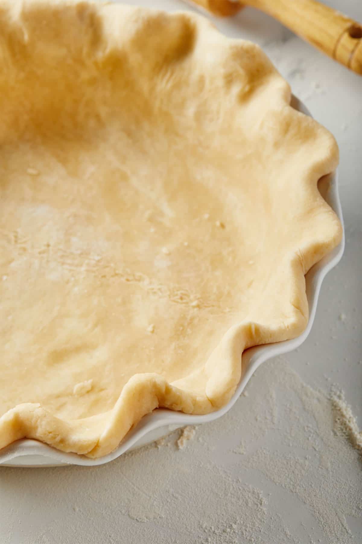A side view of the best pie crust recipe baked up in a pie plate.