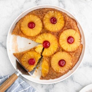 Pineapple Upside Down Cake Recipe with pineapple rings and cherries on top.