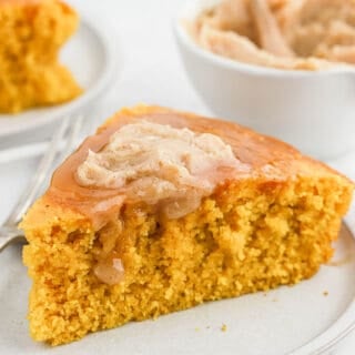 Close up of a slice brown butter pumpkin cornbread topped with butter
