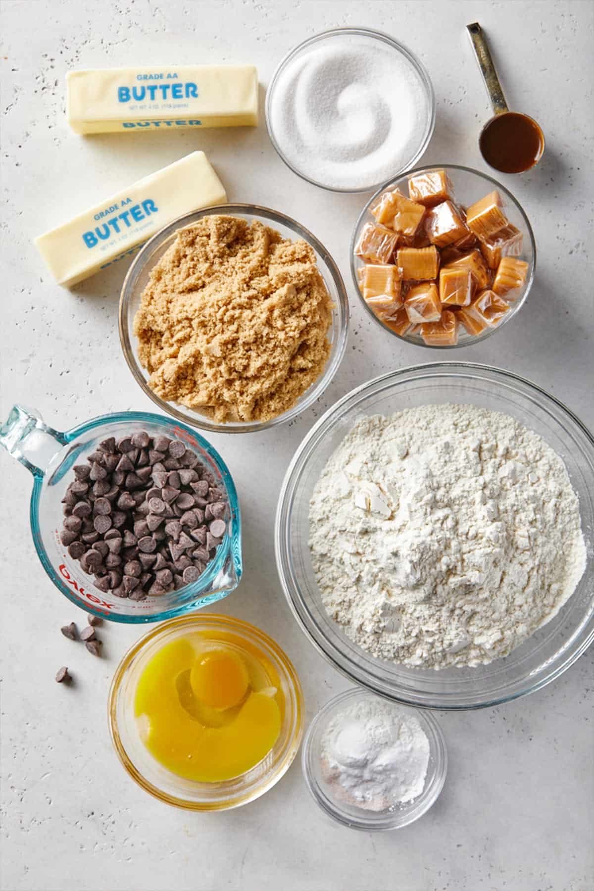 Ingredients to make salted caramel cookies with chocolate chips on the table.