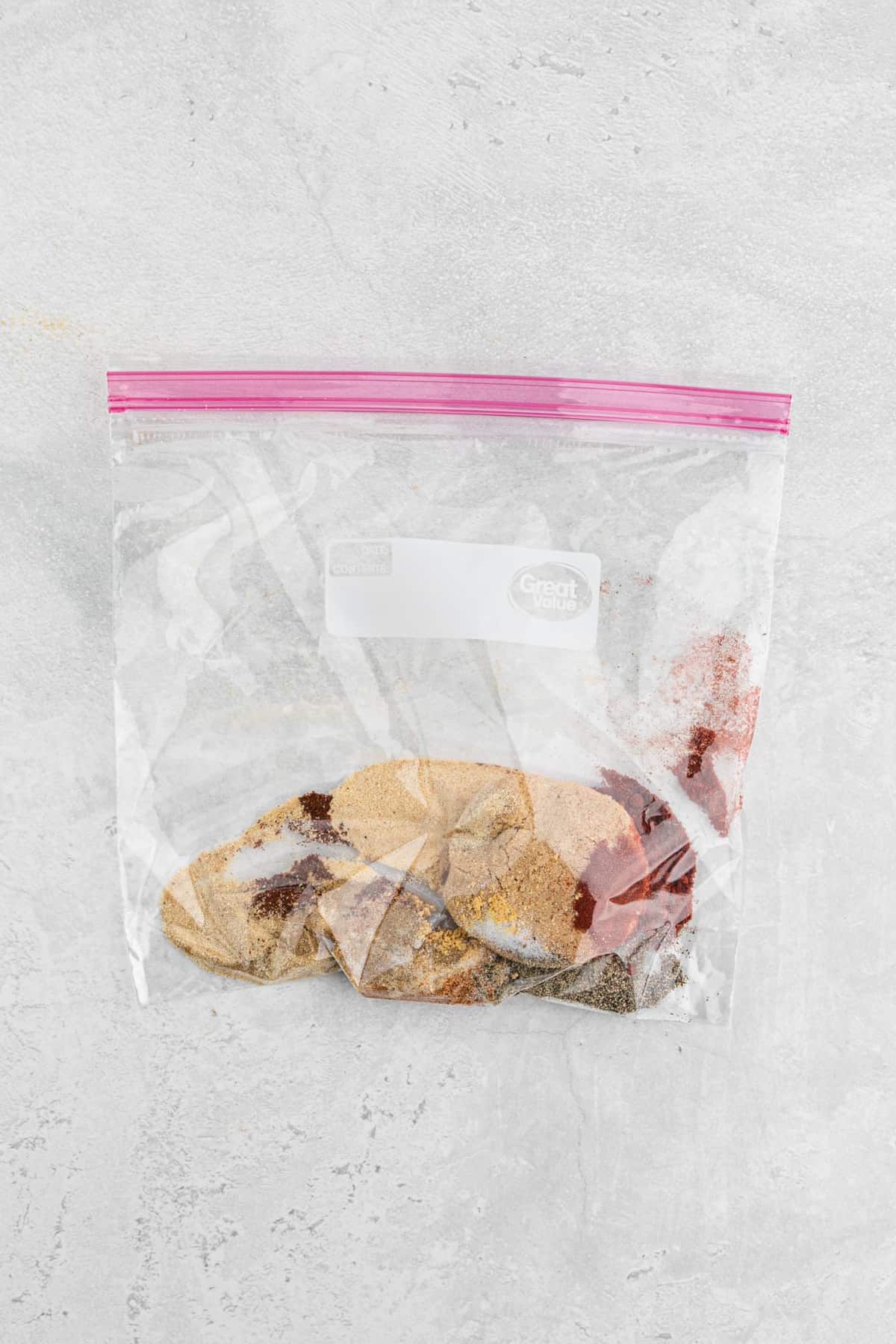 Seasonings in a ziploc bag with ribs
