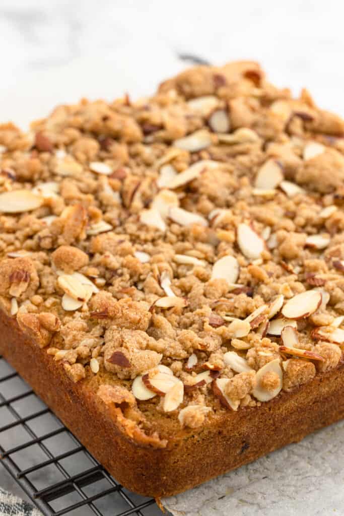 Baked crumble cake with almonds out of the oven on wire rack
