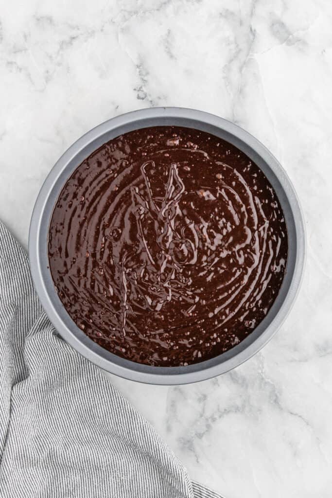 Chocolate cake batter in a pan before baking