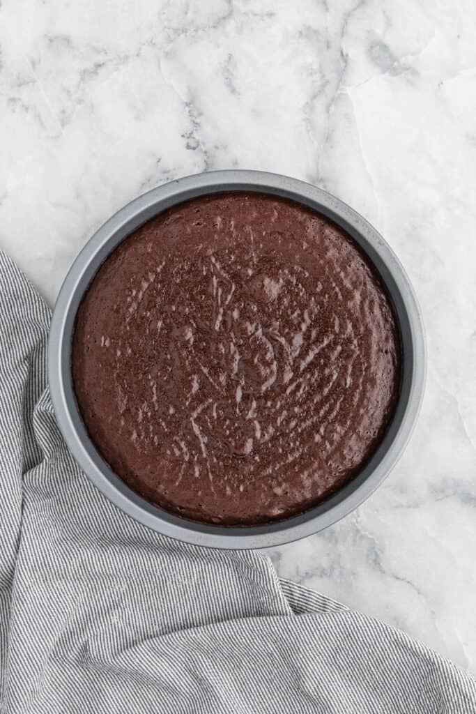 Flourless chocolate cake in pan after being pulled from oven