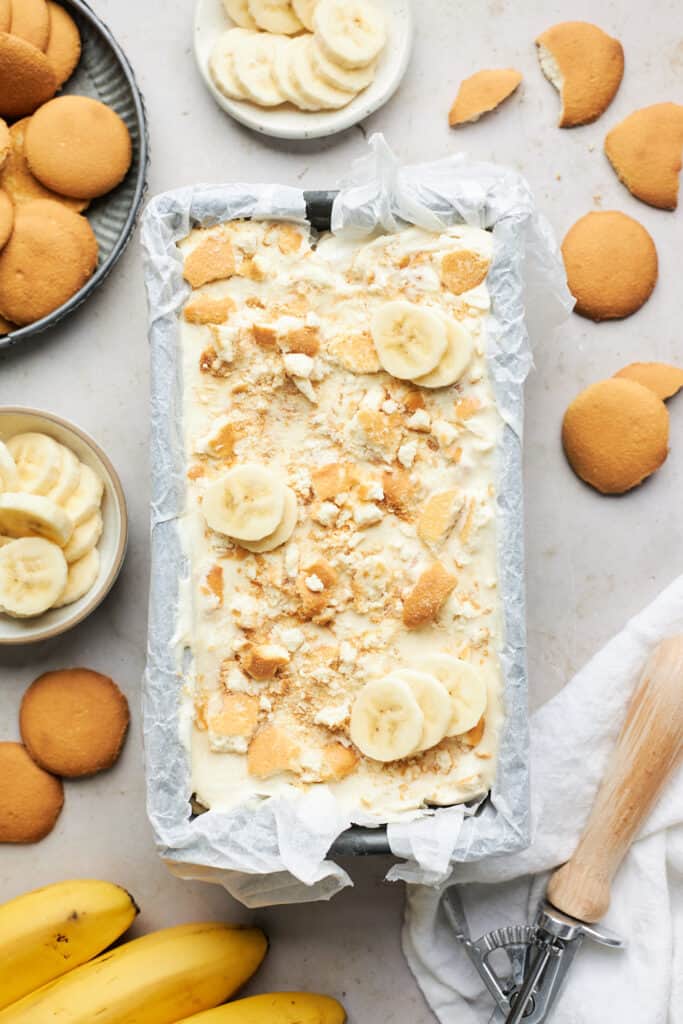 Ice cream with banana slices and nilla wafers in a deep pan before freezing