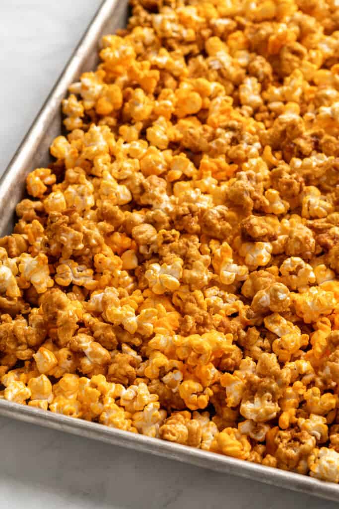 mix of cheddar and caramel popcorn on a pan.
