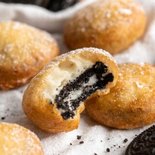 A close up of a bitten into fried oreo
