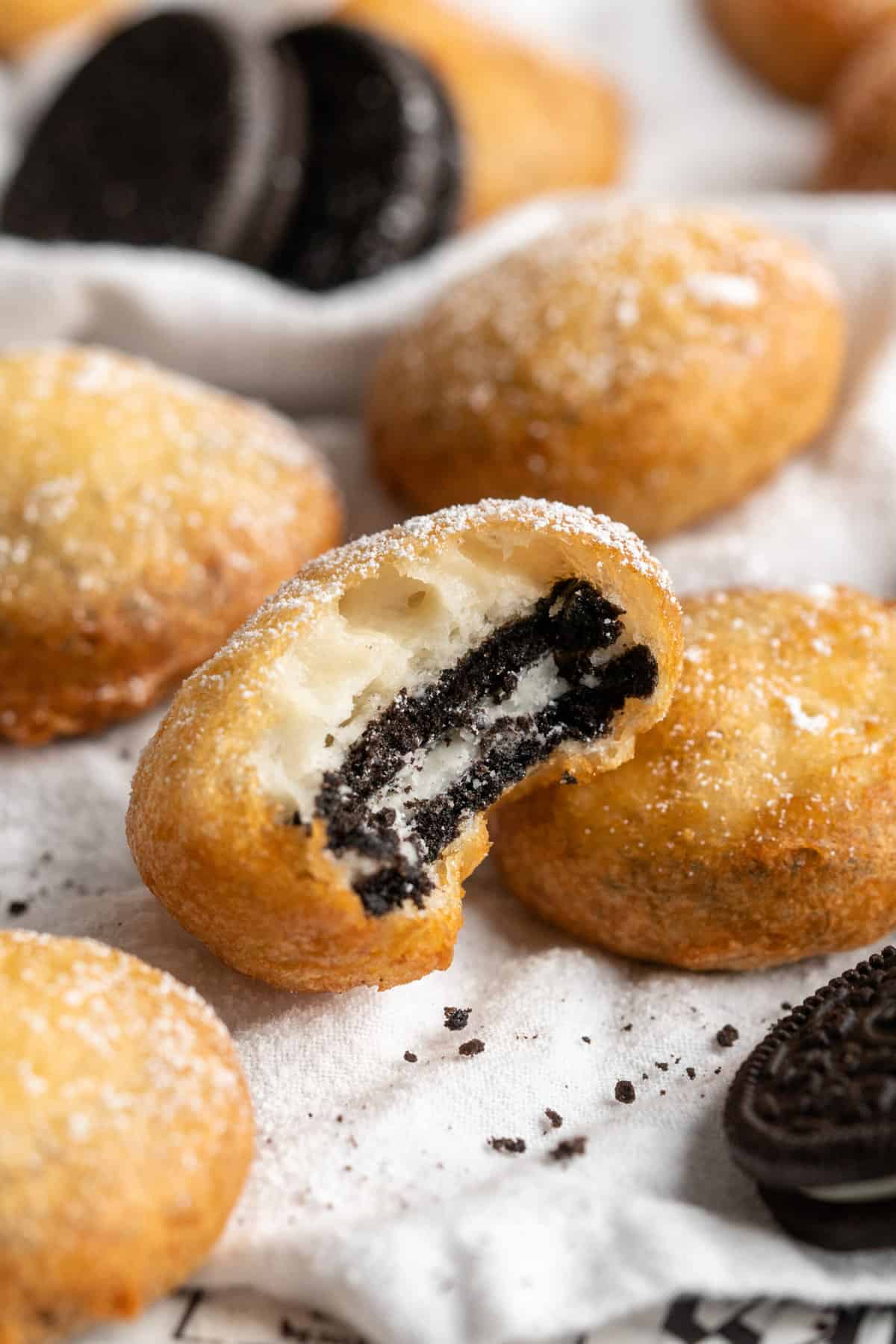 A close up of a bitten into fried oreo