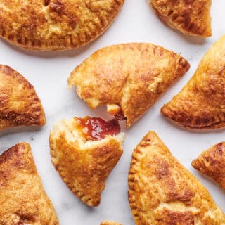 Guava empanadas on a baking sheet split open