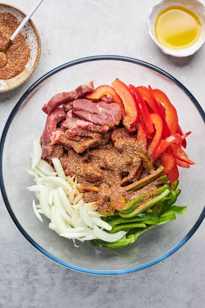 Fajita seasoning sprinkled over steak and vegetables