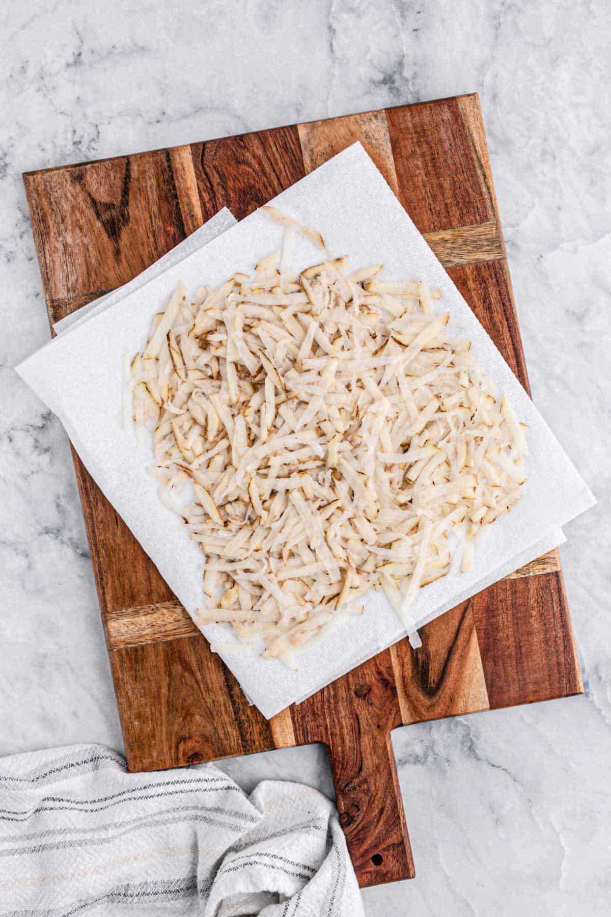 Shredded potatoes on a paper towel.