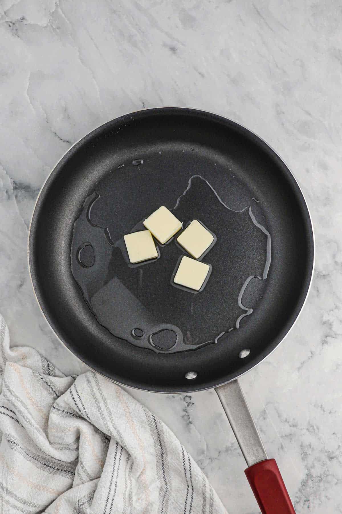 Butter and oil in a skillet to cook hash browns.