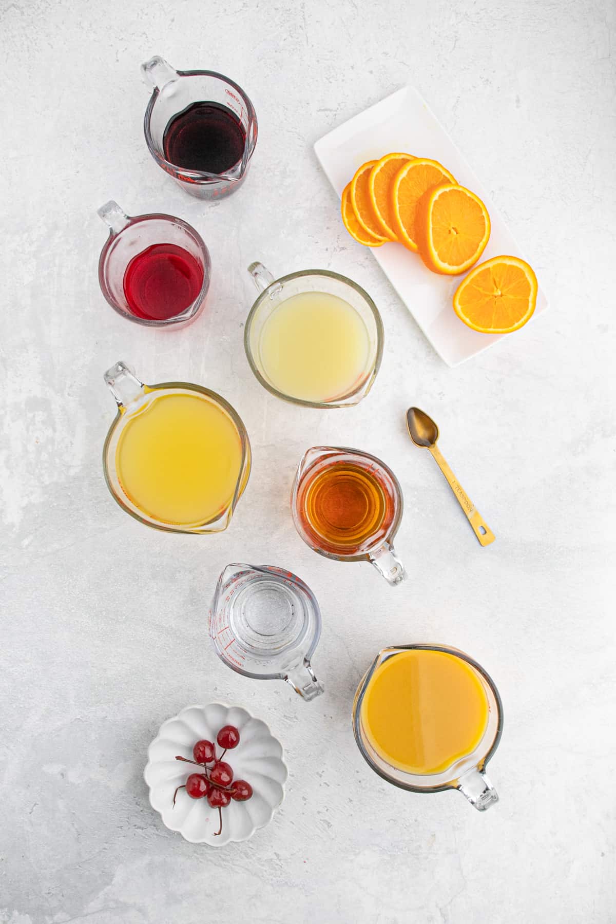 Fruit, fruit juices, slices of oranges and cherries in glass 