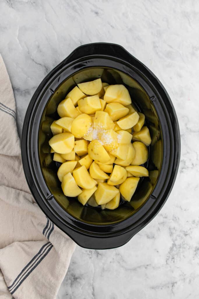 Diced potatoes in a slow cooker.