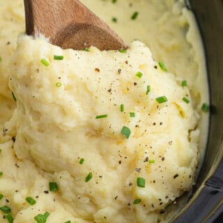 Finished slow cooker mashed potatoes garnished with chives.