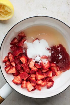 Strawberries and sugar being simmered in pot
