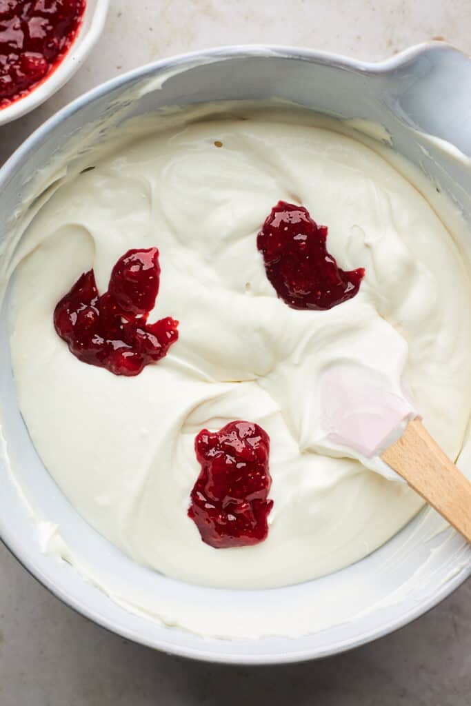 Strawberries being folded into no churn ice cream mixture
