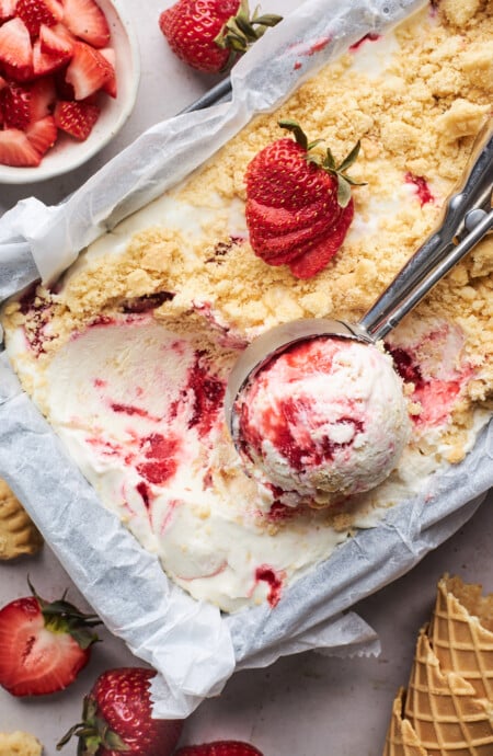 Strawberry shortcake ice cream being scooped
