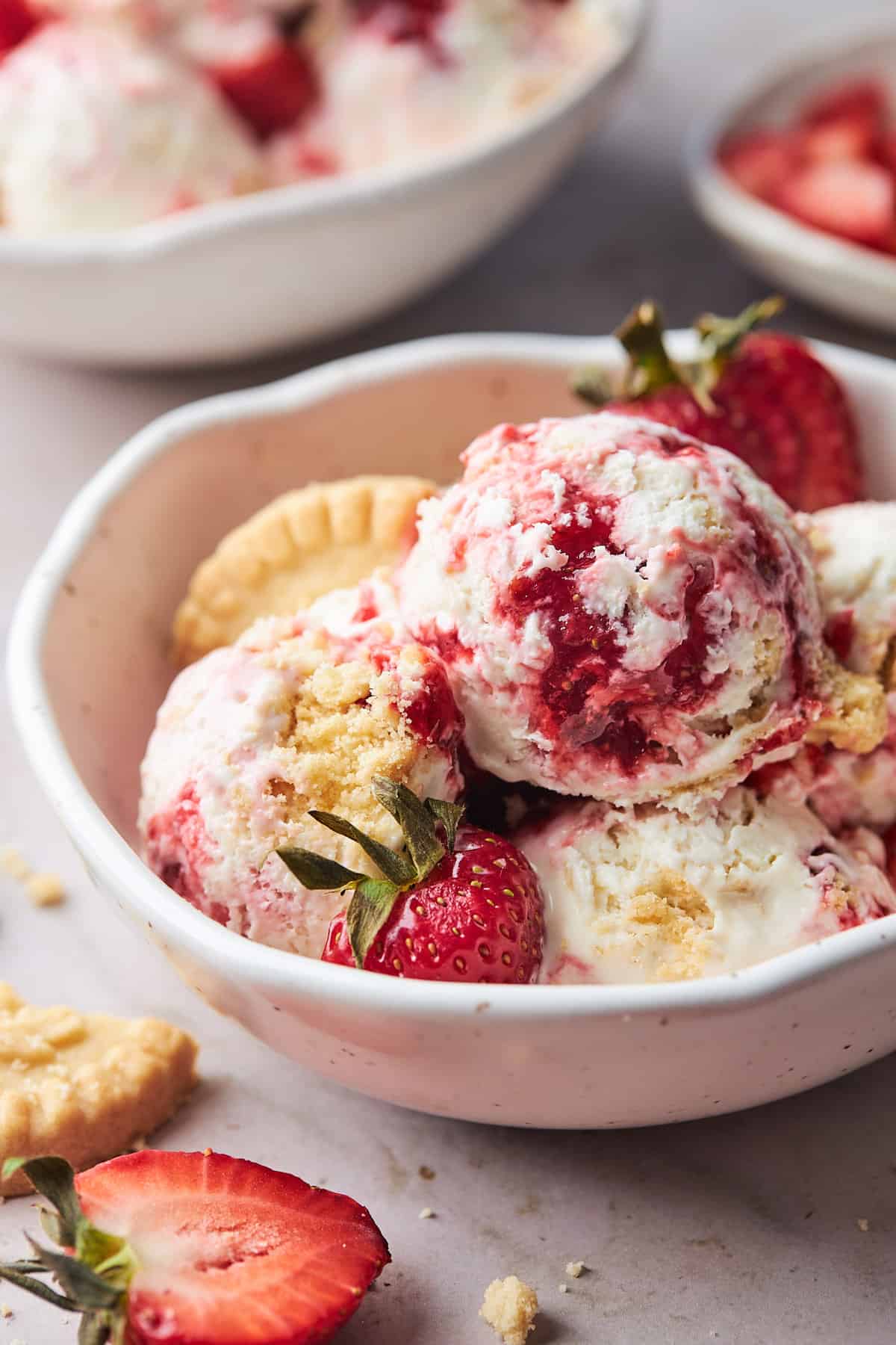 Scoops of strawberry shortcake ice cream in a large bowl ready to serve