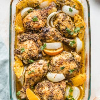 A baking dish of orange herbed baked chicken pieces.