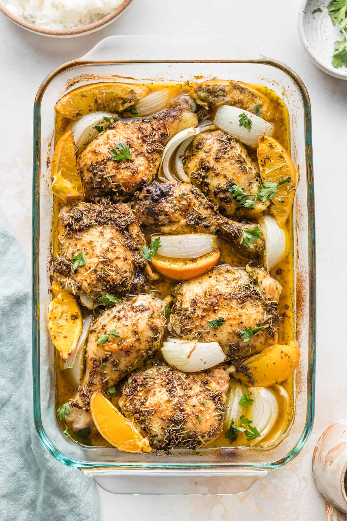 A baking dish of orange herbed baked chicken pieces.