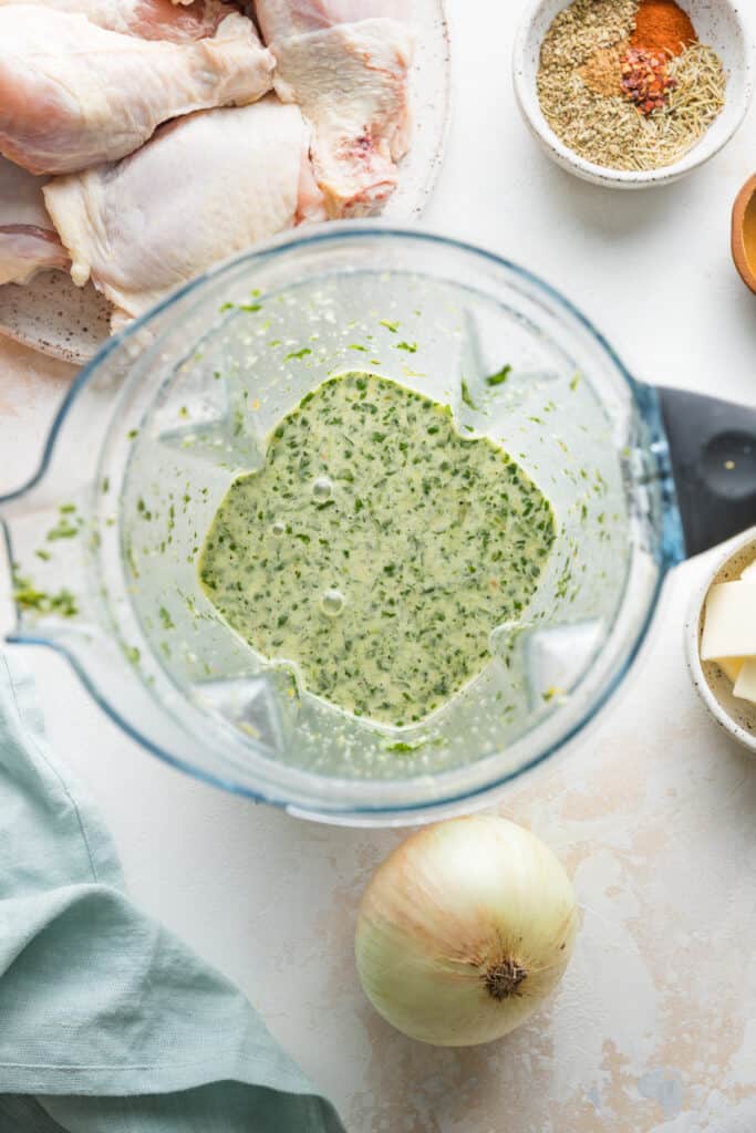 Orange herb sauce in the jar of a blender.
