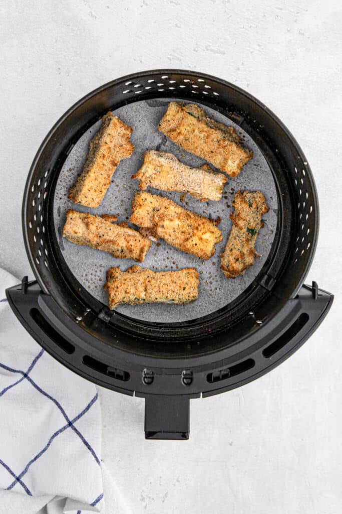 Cooked air fryer zucchini still in the air fryer basket.