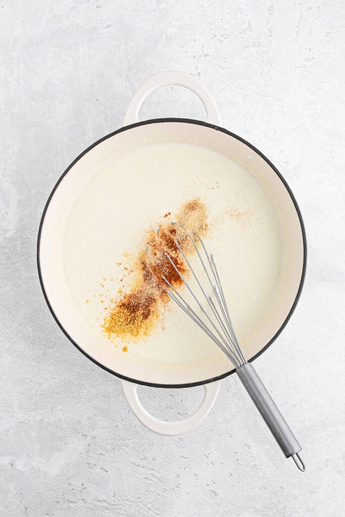 Spices added to heavy cream and milk in a large pot