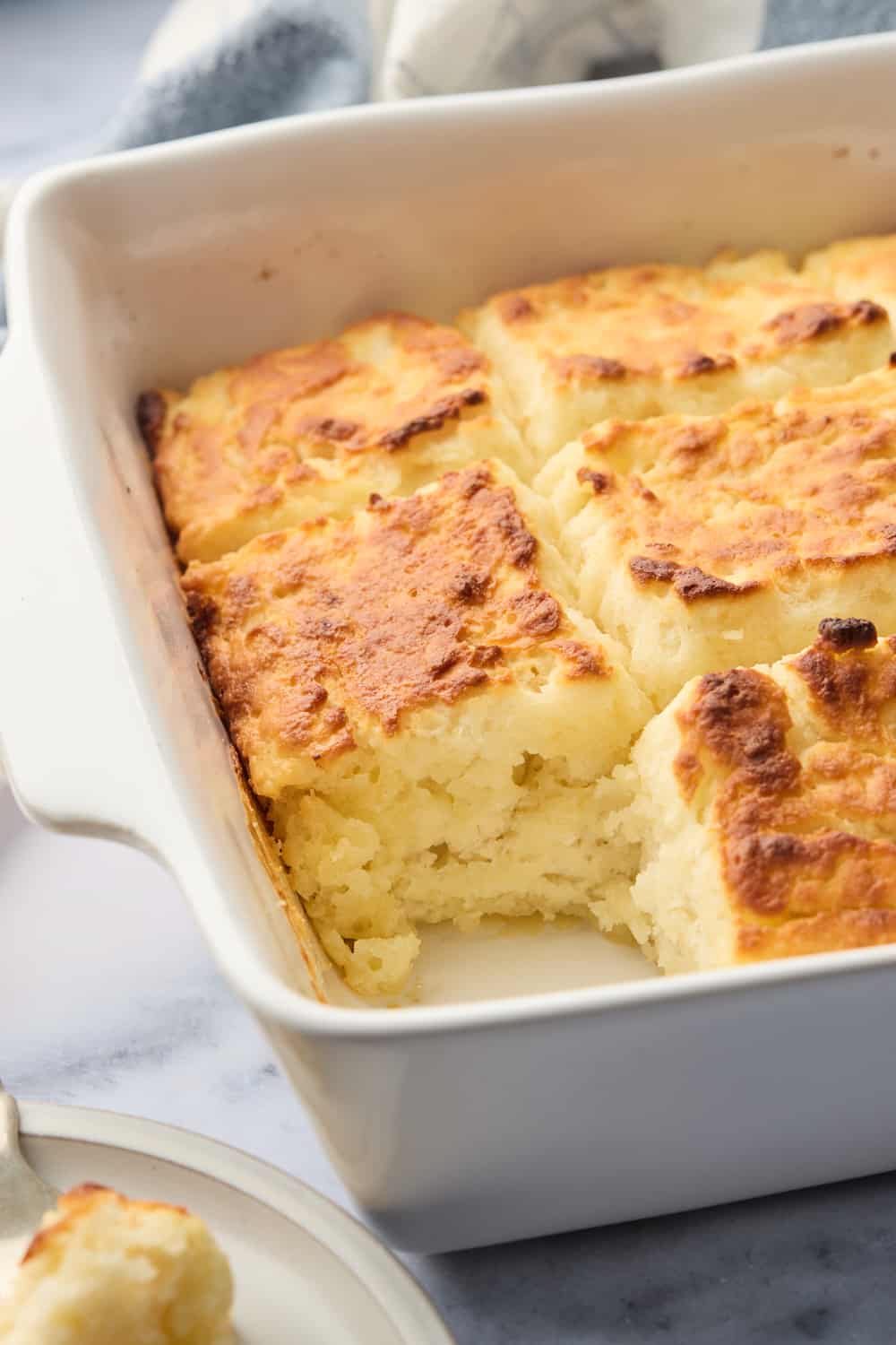 A pan of biscuits with one missing on a plate