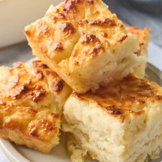 4 squares of butter swim biscuits stacked on a plate