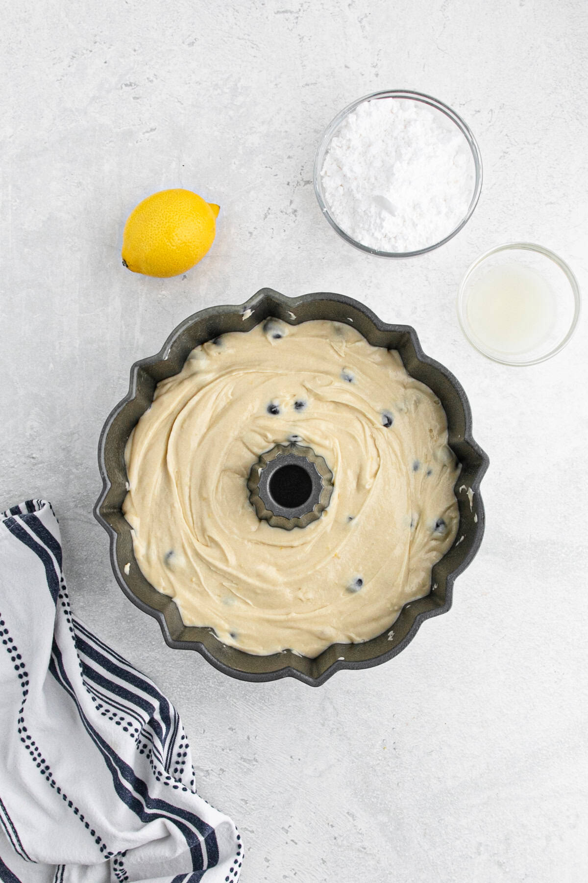 Lemon blueberry batter spread evenly in a bundt pan before baking